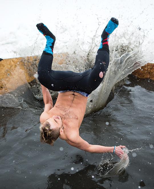 student jumping into cold water at polar plunge
